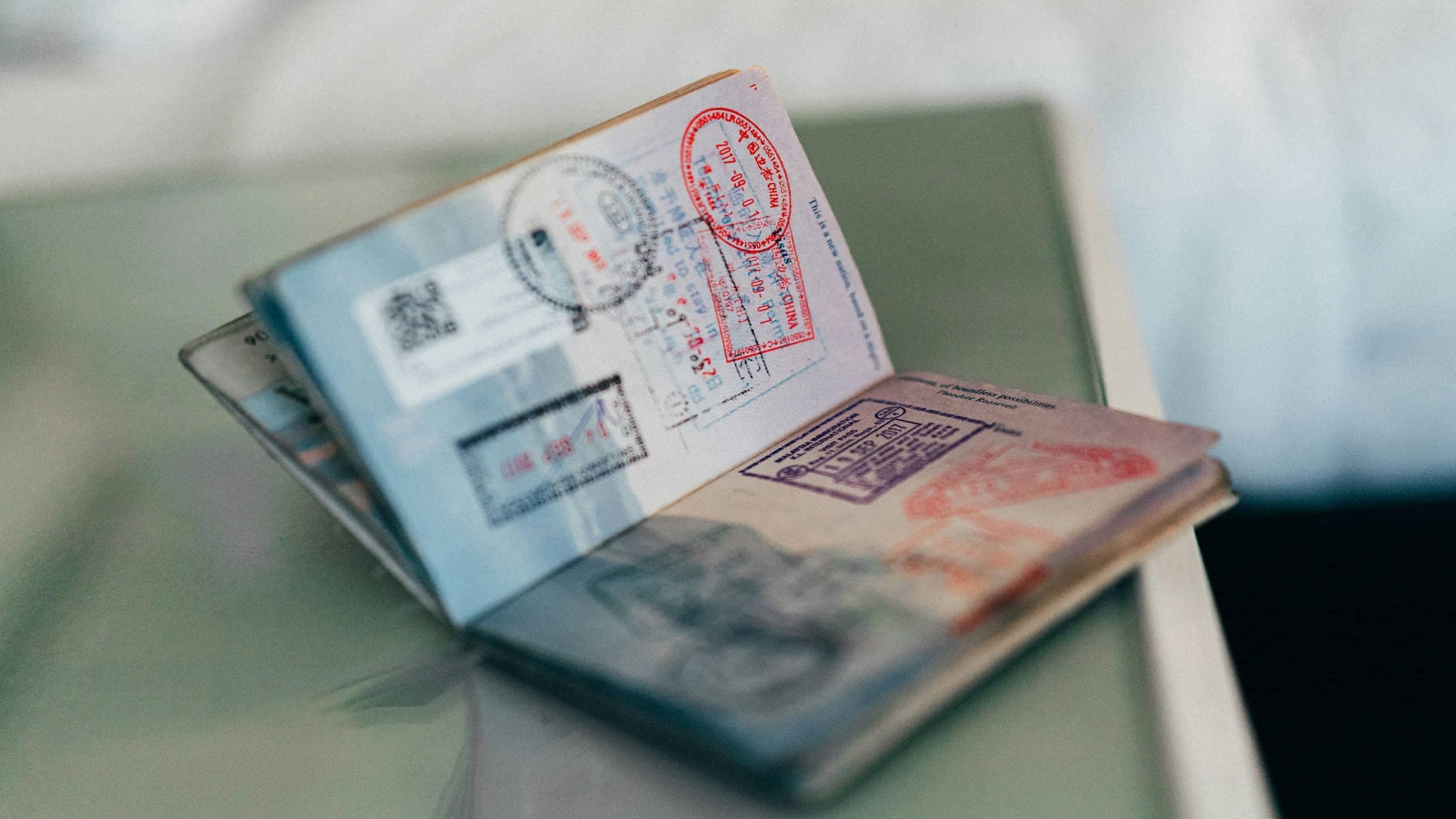 An open passport filled with visa and immigration stamps